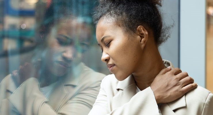 African office worker woman having shoulder sickness or neck pain from overwork or office syndrome. AdobeStock_631459944
